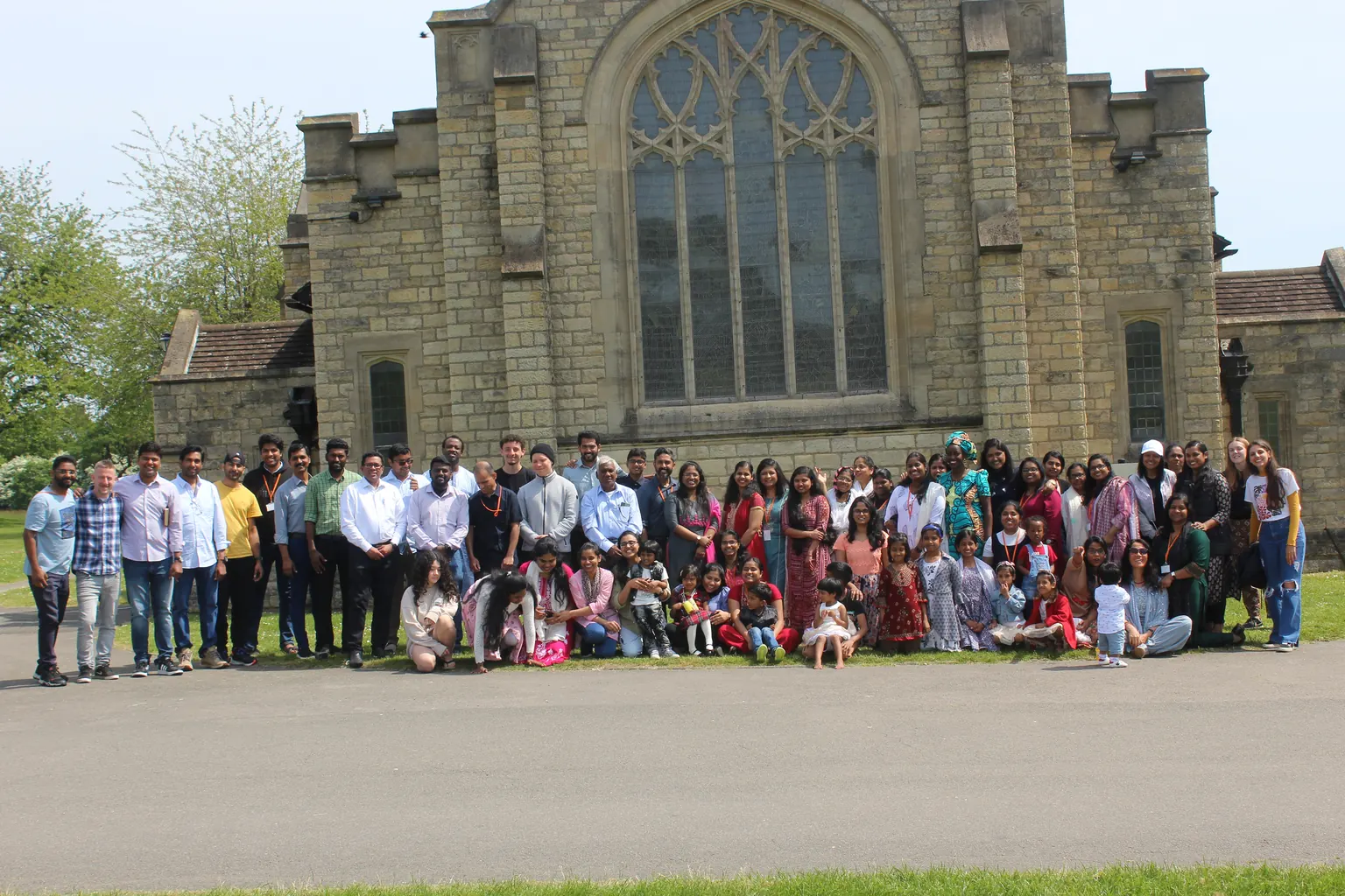 The Spring Valley Church family gathered for a group photo outside a stone church