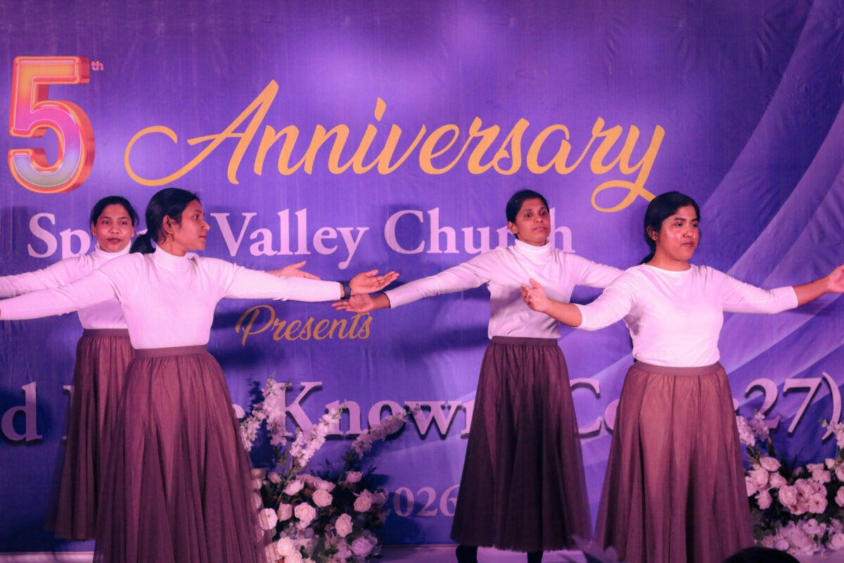 Women singing on stage at the 5th anniversary celebration